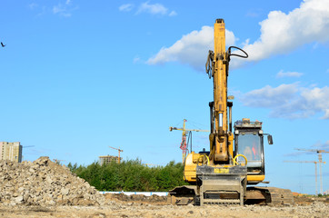Excavator with crusher bucket for crushing concrete. Construction waste recycling for construction...