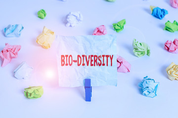 Handwriting text Bio Diversity. Conceptual photo Variety of Life Organisms Marine Fauna Ecosystem Habitat Colored crumpled papers empty reminder white floor background clothespin