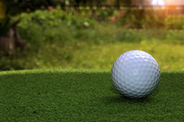 Golf equipment in beautiful golf course at sunset background.