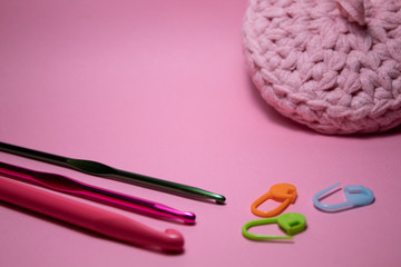 Crochet hooks. On a pink background. There is a place for text. Copy space.