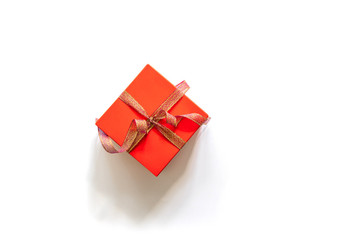 Creative Christmas composition of gift box with gold tape on white background. Top view with copy space.