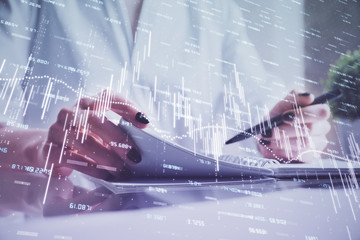 Financial chart drawn over hands taking notes background. Concept of research. Multi exposure