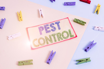 Writing note showing Pest Control. Business concept for analysisagement of a species that impacts adversely on huanalysis Colored clothespin paper reminder with yellow blue background