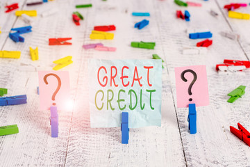 Conceptual hand writing showing Great Credit. Concept meaning borrower has high credit score and is a safe credit risk Crumbling sheet with paper clips placed on the wooden table