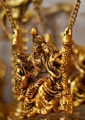 Fototapeta na wymiar Closeup view of Bronze metallic Hindu god Krishna and radha figurine in display of a shop 