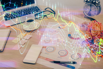 Forex market chart hologram and personal computer background. Double exposure. Concept of...