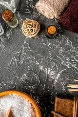 spa set with towels and soap on dark background top view mock up