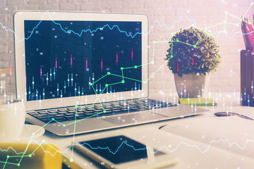 Financial graph colorful drawing and table with computer on background. Double exposure. Concept of international markets.