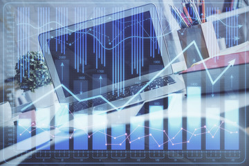 Double exposure of chart and financial info and work space with computer background. Concept of...
