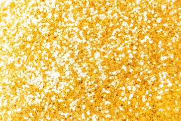 Festive bright background: golden sparkles close-up. Beautiful deep color and overflow. Party concept. Place for text..