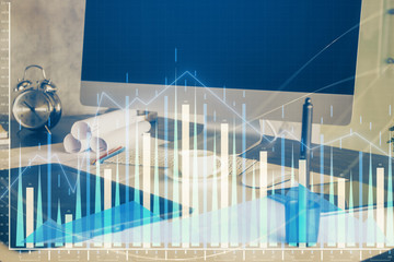 Naklejka premium Stock market chart hologram drawn on personal computer background. Multi exposure. Concept of investment.