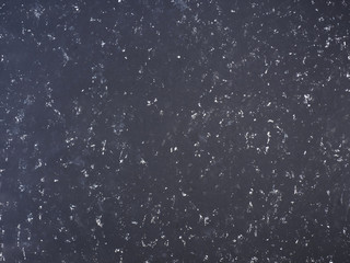 Black concrete background with white spot