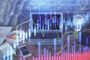 Double exposure of graph and financial info and work space with computer background. Concept of...