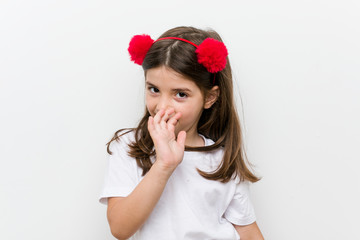 Little caucasian girl with costume and accessories having fun