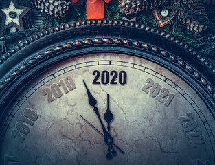 Fototapeta na wymiar On the New Year's clock 2020. The old clock points to two thousand and twenty arrows.
