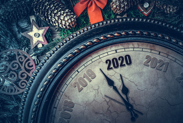 On the New Year's clock 2020. The old clock points to two thousand and twenty arrows.