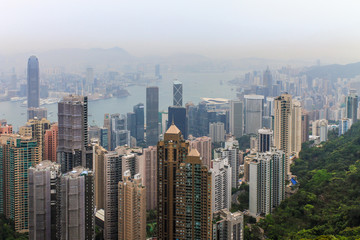 Fototapeta na wymiar View on Skyscrapers with Victoria Bay, Transportation Ships, Harbour and Kowloon taken from Hongkong Island Peak. Hong Kong, China