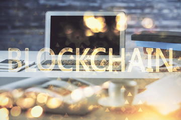 Multi exposure of blockchain theme hologram and table with computer background. Concept of bitcoin crypto currency.