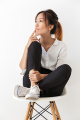 Attractive young asian woman sitting on a chair