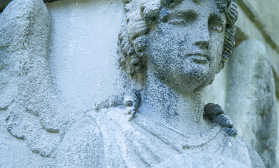 Pain and sorrow concept. Fragment of ancient statue of sad angel.