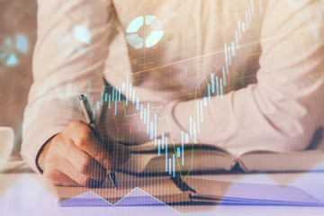 Financial trading chart double exposure with man desktop background.