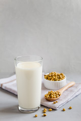 Soy milk in a glass and beans in a plate. The concept of healthy eating. Vegetarian food. Vegetable...