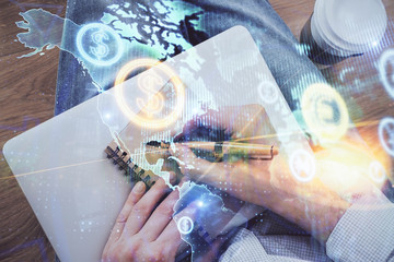 Double exposure of man doing notes of stock market with forex graph.