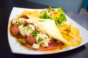 Sausage crepe dipped in tiramisu sauce.