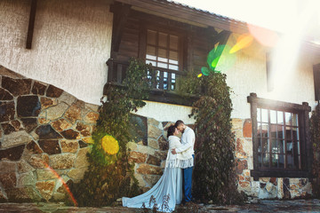 Beautiful and happy young couple man and woman in a beautiful garden in the yard of a country house