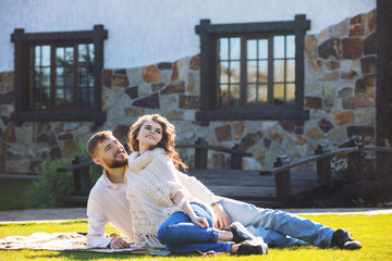 Beautiful and happy young couple man and woman in a beautiful garden in the yard of a country house