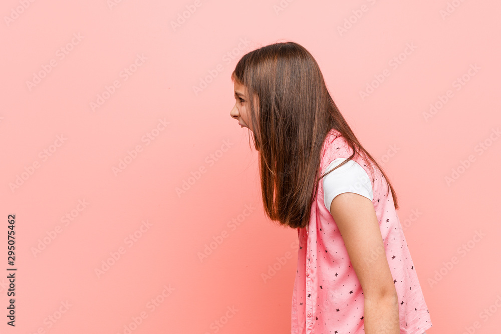 Wall mural Cute little girl shouting towards a copy space