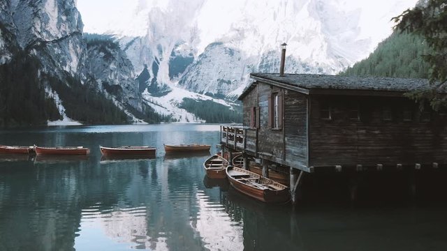 Old boat house with rowing boats at Lago di Braies, Dolomites, Italy