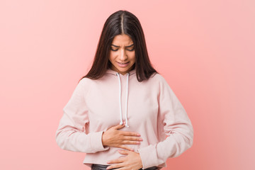 Young pretty arab woman wearing a casual sport look sick, suffering from stomachache, painful...
