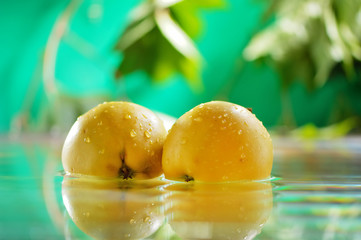 Apples yellow in water. Fresh fruits to wash, peel. Water is poured onto apples. Water falls on apples.