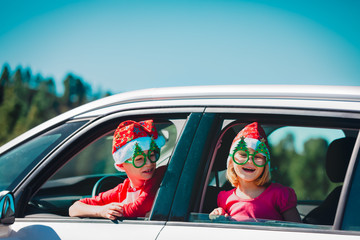 christmas car travel- happy boy and girl travel in winter