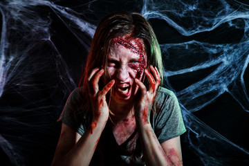 portrait of horrible zombie woman with wounds. Horror. Halloween make-up and costume