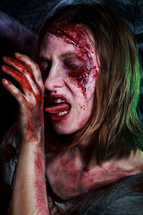 portrait of horrible zombie woman with wounds. Horror. Halloween make-up and costume