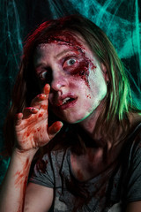 Close-up portrait of horrible zombie woman with wounds. Horror. Halloween make-up and costume