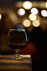 Whiskey in glass for adult on counter bar at to night.