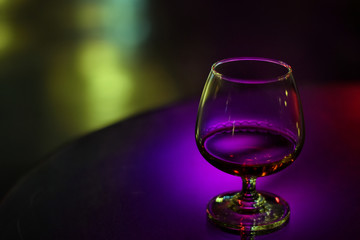 Whiskey in glass for adult on counter bar at to night.