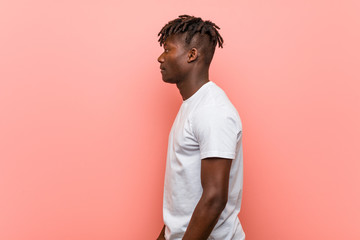 Young african black man gazing left, sideways pose.
