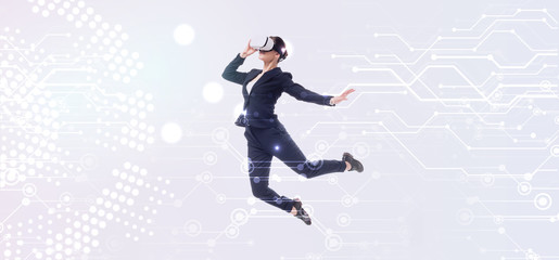 Fototapeta na wymiar panoramic shot of businesswoman in virtual reality headset levitating on grey background with abstract cyberspace illustration