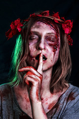 Close-up portrait of horrible zombie woman with wounds. Horror. Halloween poster. The shouting...