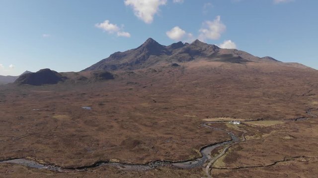 Cuillin Hills Mountain Range, Monro, Small White Cottage, Isle Of Skye, Aerial Sunny Spring Day 4K Cine D