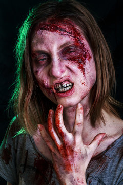 Close-up portrait of horrible zombie woman with wounds. Horror. Halloween poster. The shouting female zombie