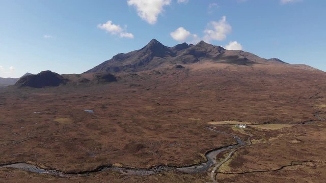 Cuillin Hills Mountain Range, Monro, Small White Cottage, Isle Of Skye, Aerial Sunny Spring Day 4K