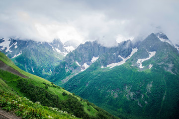 Fototapeta na wymiar mountain landscape - mountains forest, rocks glaciers snow clouds, Dombay, Karachay-Cherkessia, Russia