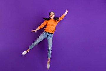 Full size photo of positive cheerful teen girl hold hand jump catch her flying parasol on windy...