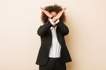 Young business african american woman keeping two arms crossed, denial concept.