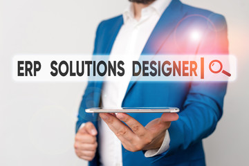 Text sign showing Erp Solutions Designer. Business photo showcasing elegant optimized modularised and reusable possible Man in the blue suite and white shirt holds mobile phone in the hand